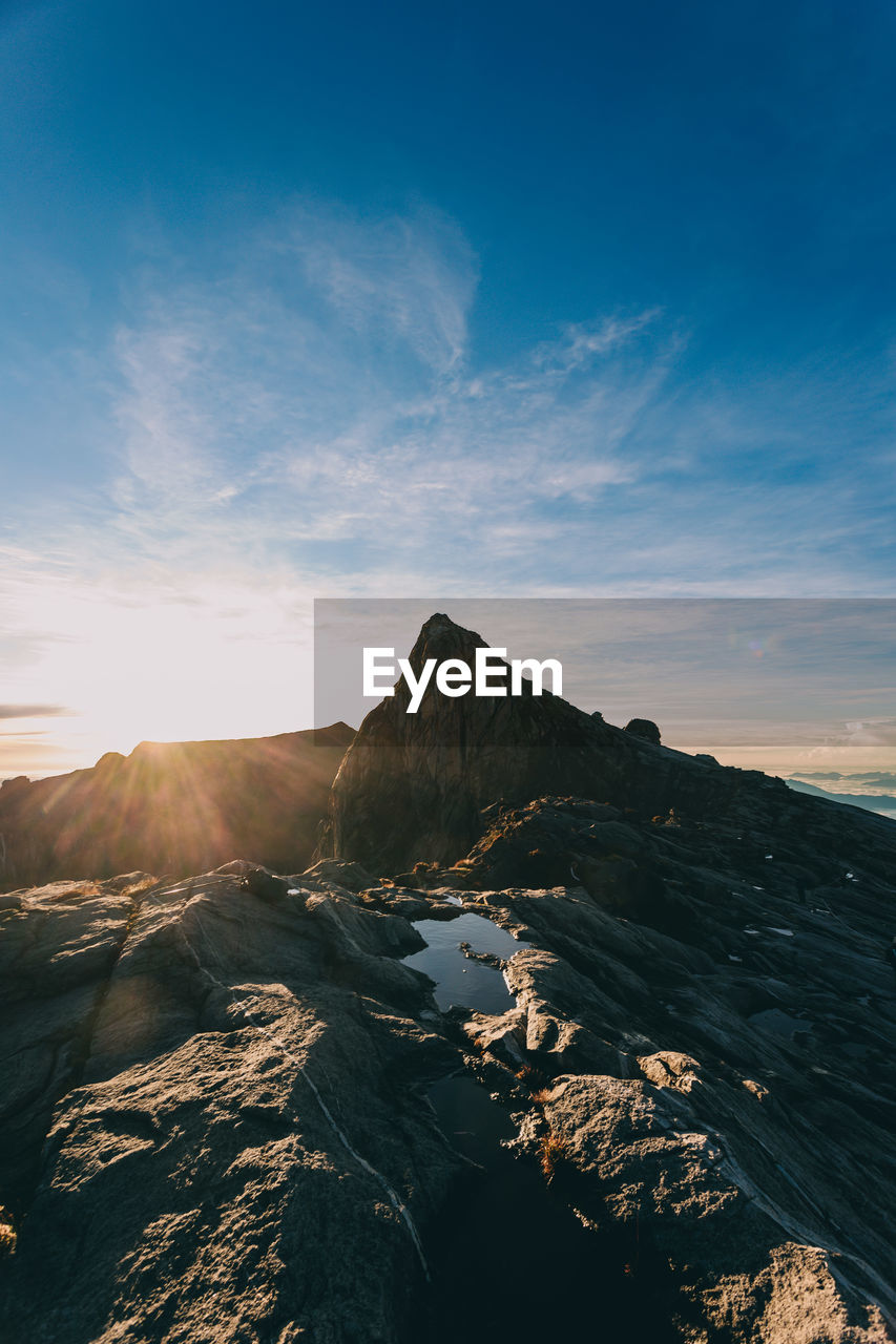 PANORAMIC VIEW OF MOUNTAIN AGAINST CLOUDY SKY