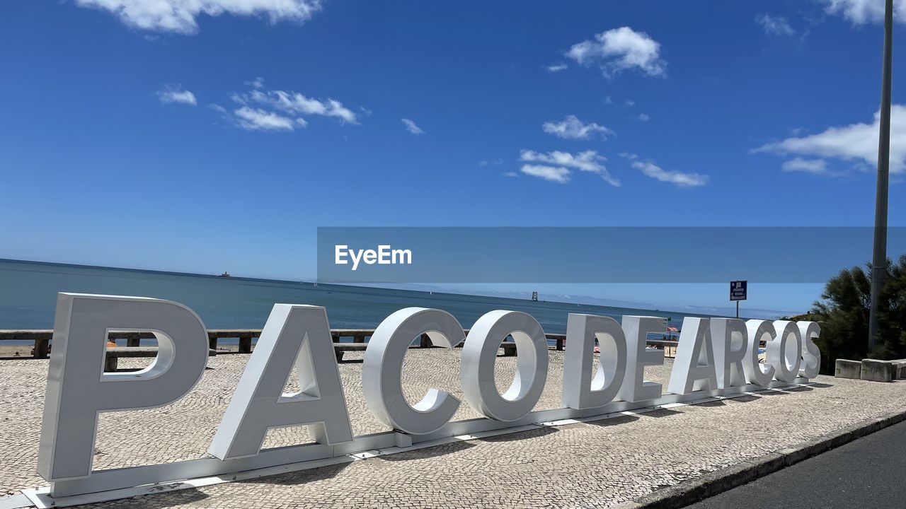 TEXT ON BEACH AGAINST SKY