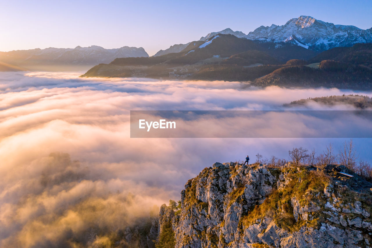 SCENIC VIEW OF SNOWCAPPED MOUNTAIN AGAINST SKY DURING SUNSET