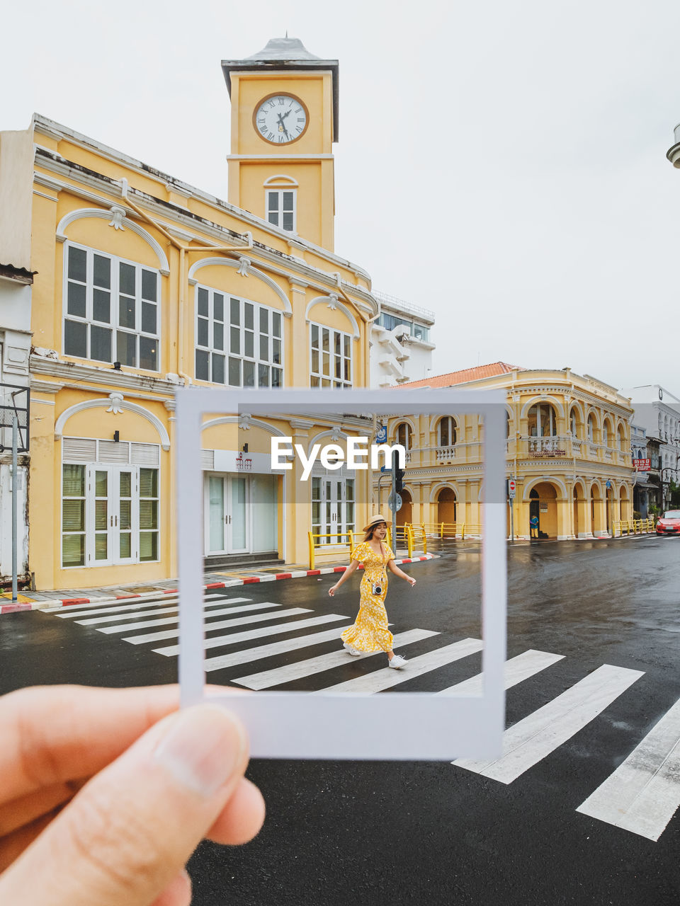 cropped hand of man holding building