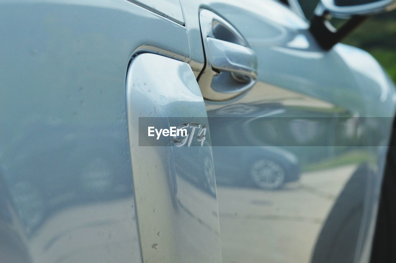 CLOSE-UP OF CAR ON SIDE-VIEW MIRROR