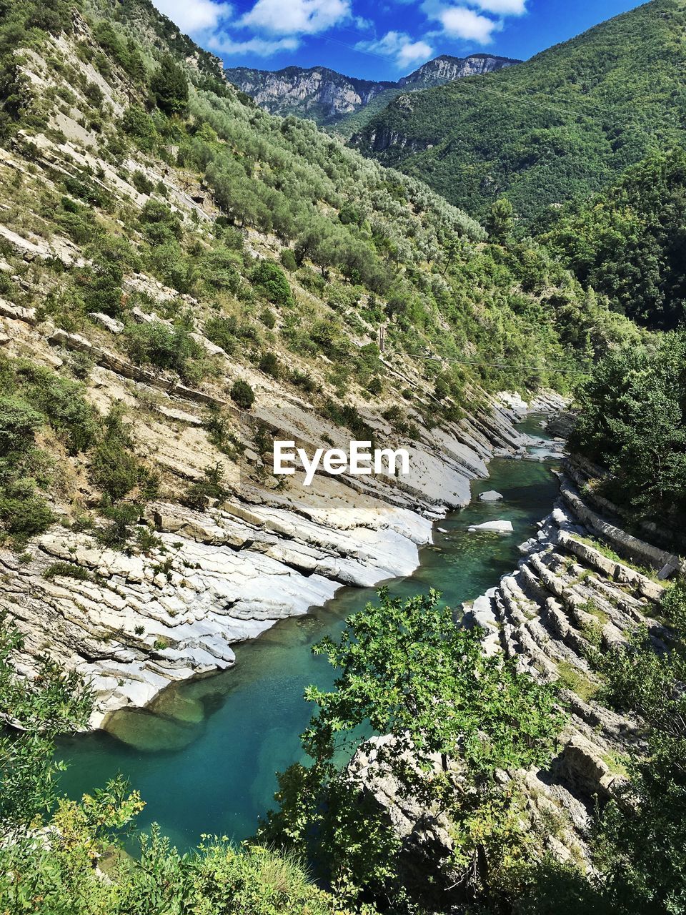 Scenic view of river and mountains against sky