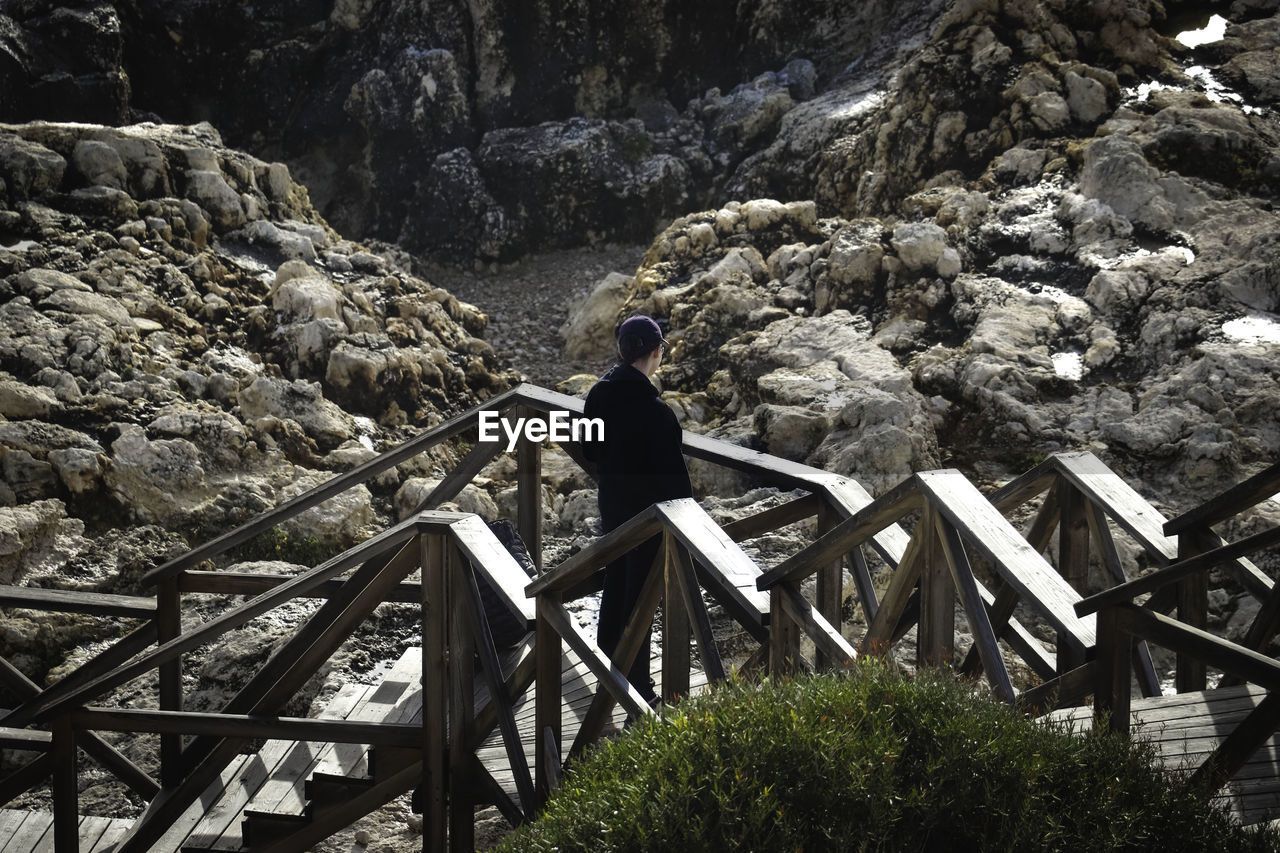 High angle view of boy standing on steps