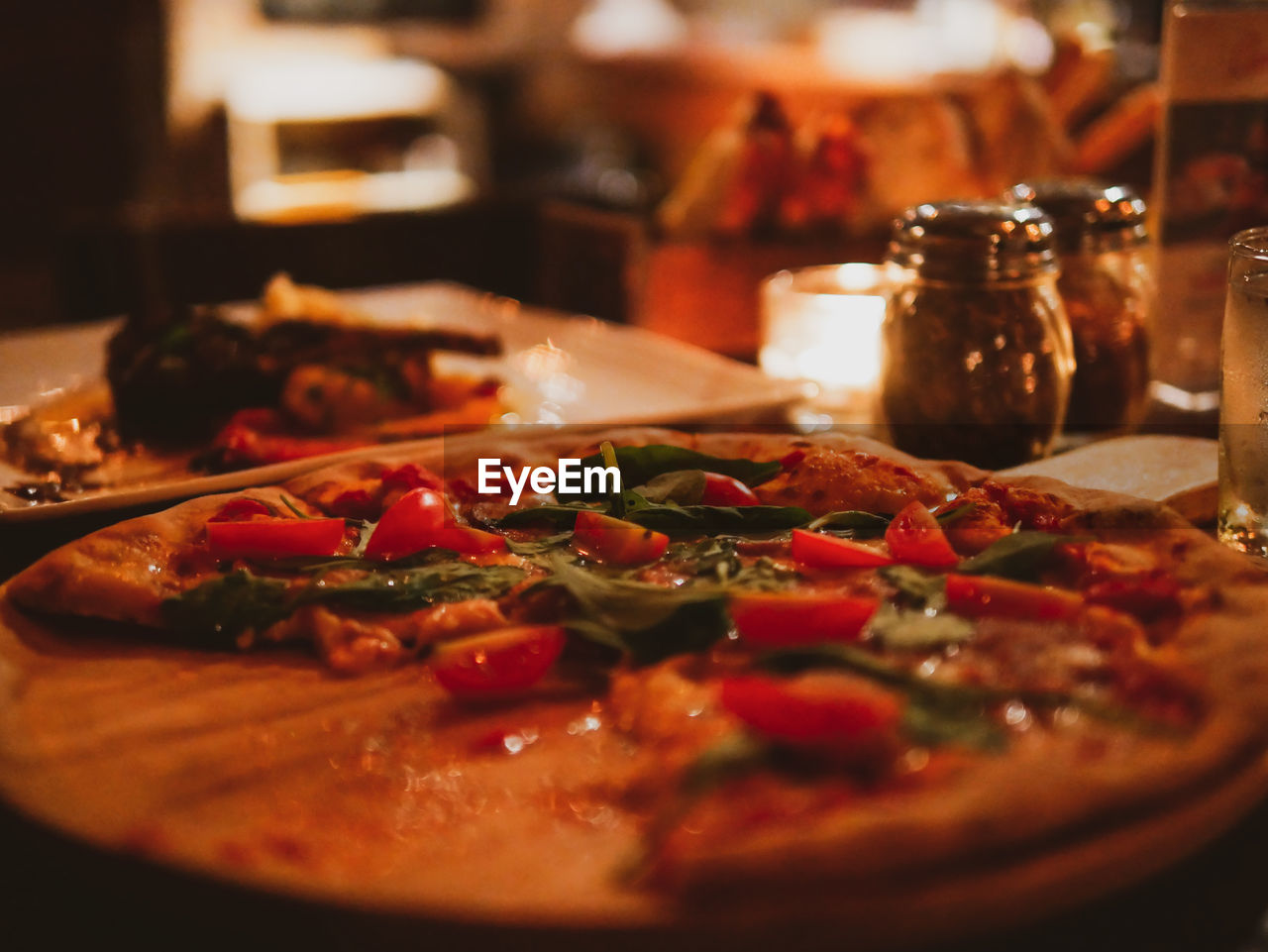 CLOSE-UP OF PIZZA ON TABLE IN RESTAURANT