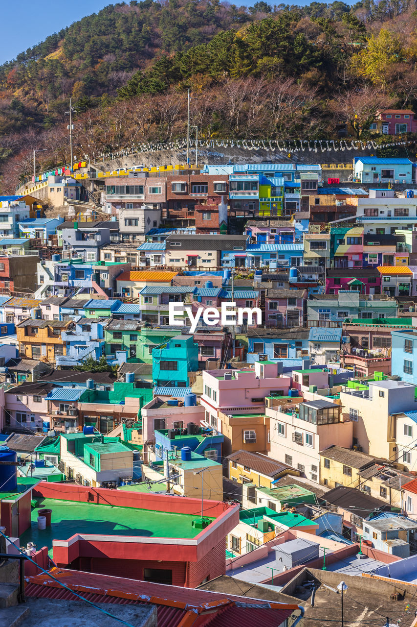 architecture, town, building exterior, city, building, built structure, nature, land, mountain, house, residential district, water, multi colored, travel destinations, no people, high angle view, cityscape, travel, transportation, outdoors, day, environment, community, harbor, sea, neighbourhood, landscape, tourism, roof, aerial photography, business finance and industry, nautical vessel, beach, street