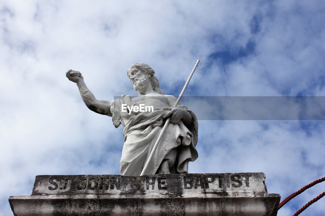 Low angle view of statue against sky