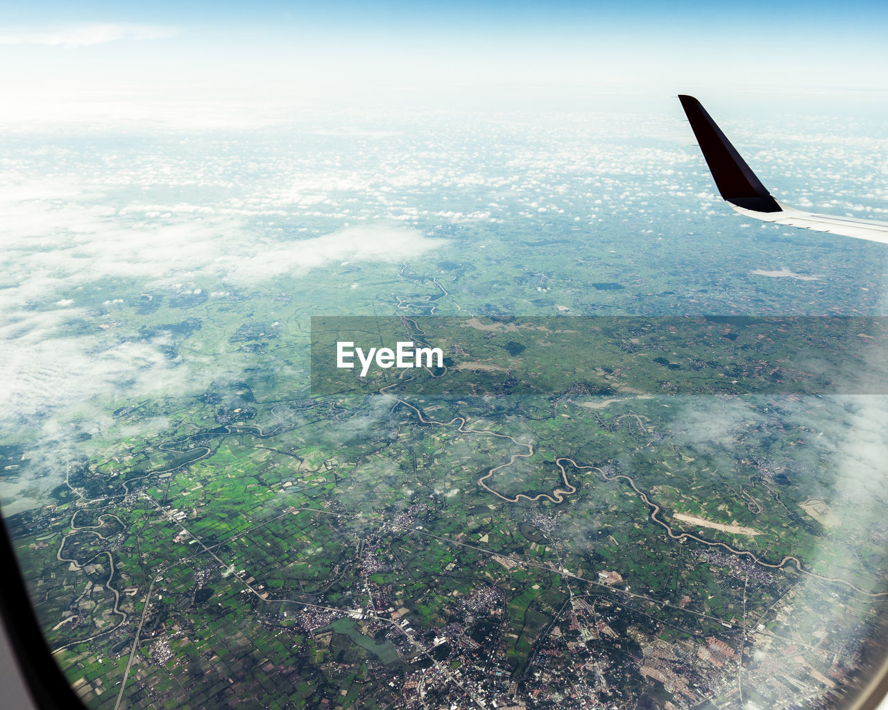 Cropped image of airplane flying over sea