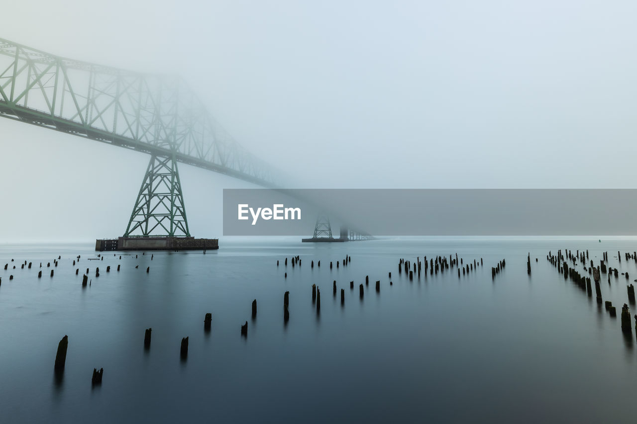 Bridge over sea against sky