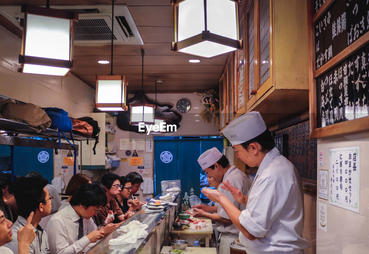 PEOPLE WORKING IN KITCHEN