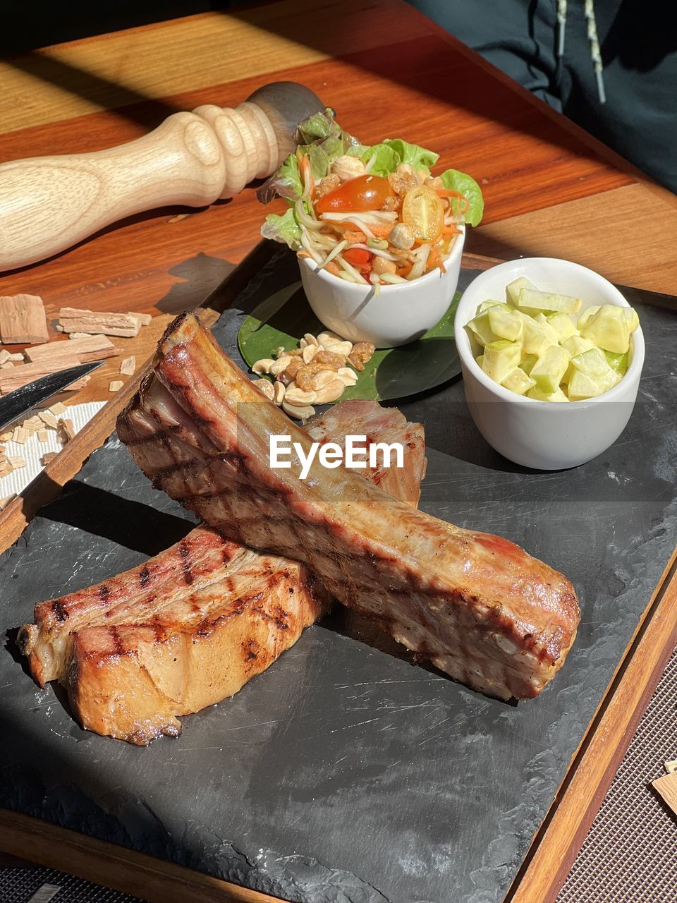 Cropped hand of person preparing food on table