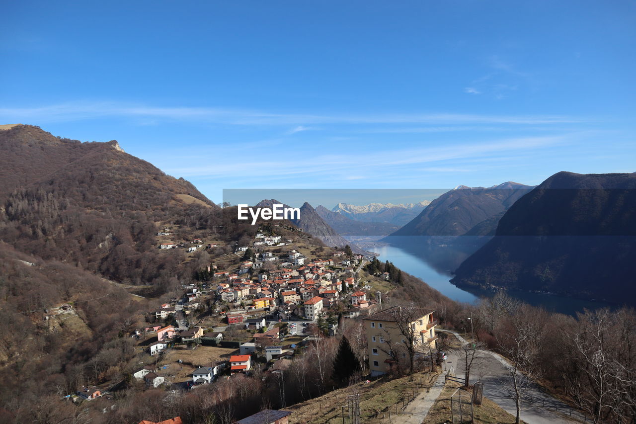 Town by mountains against sky