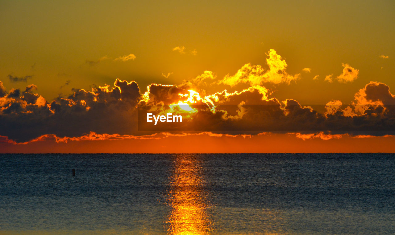 Scenic view of sea against orange sky