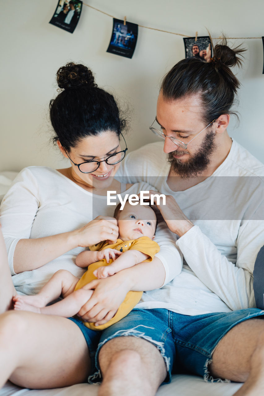 Midsection of mother and daughter sitting at home