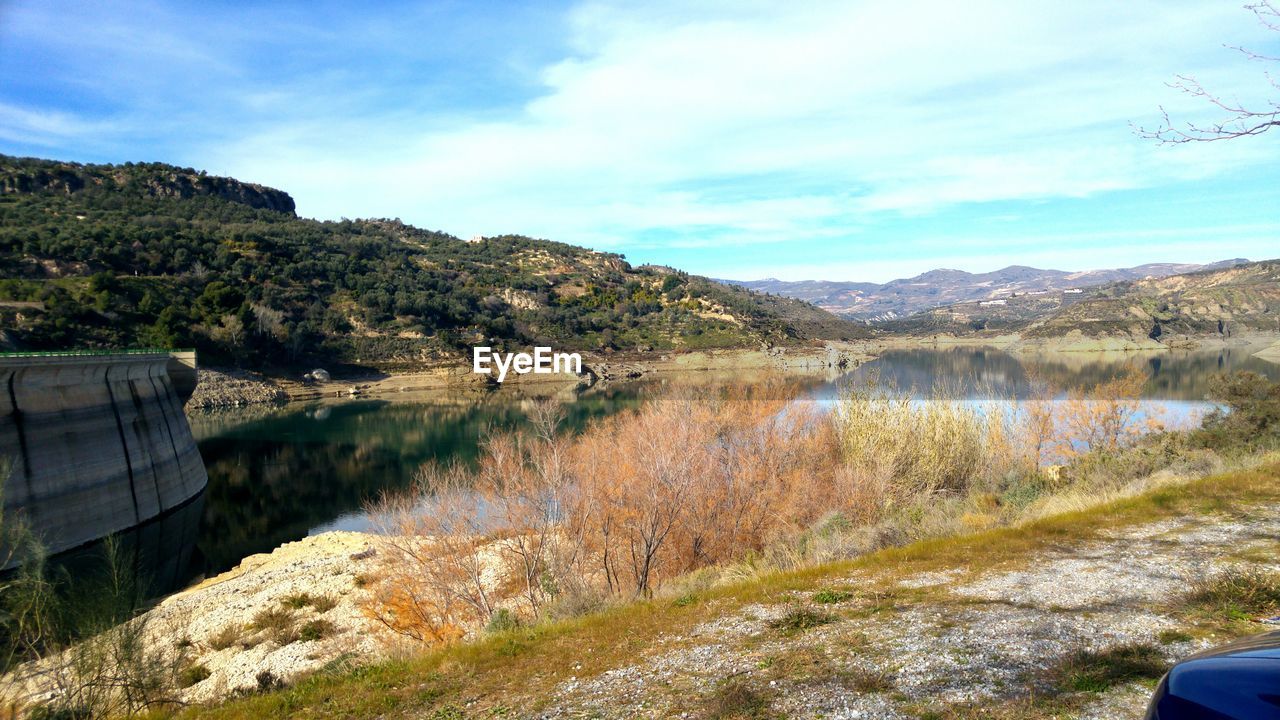 SCENIC VIEW OF LAKE BY TREES AGAINST SKY