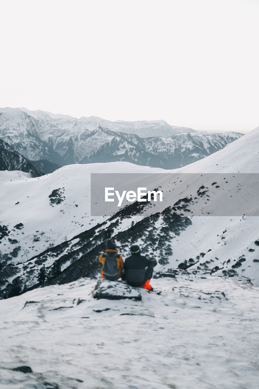 Scenic view of snowcapped mountains against clear sky