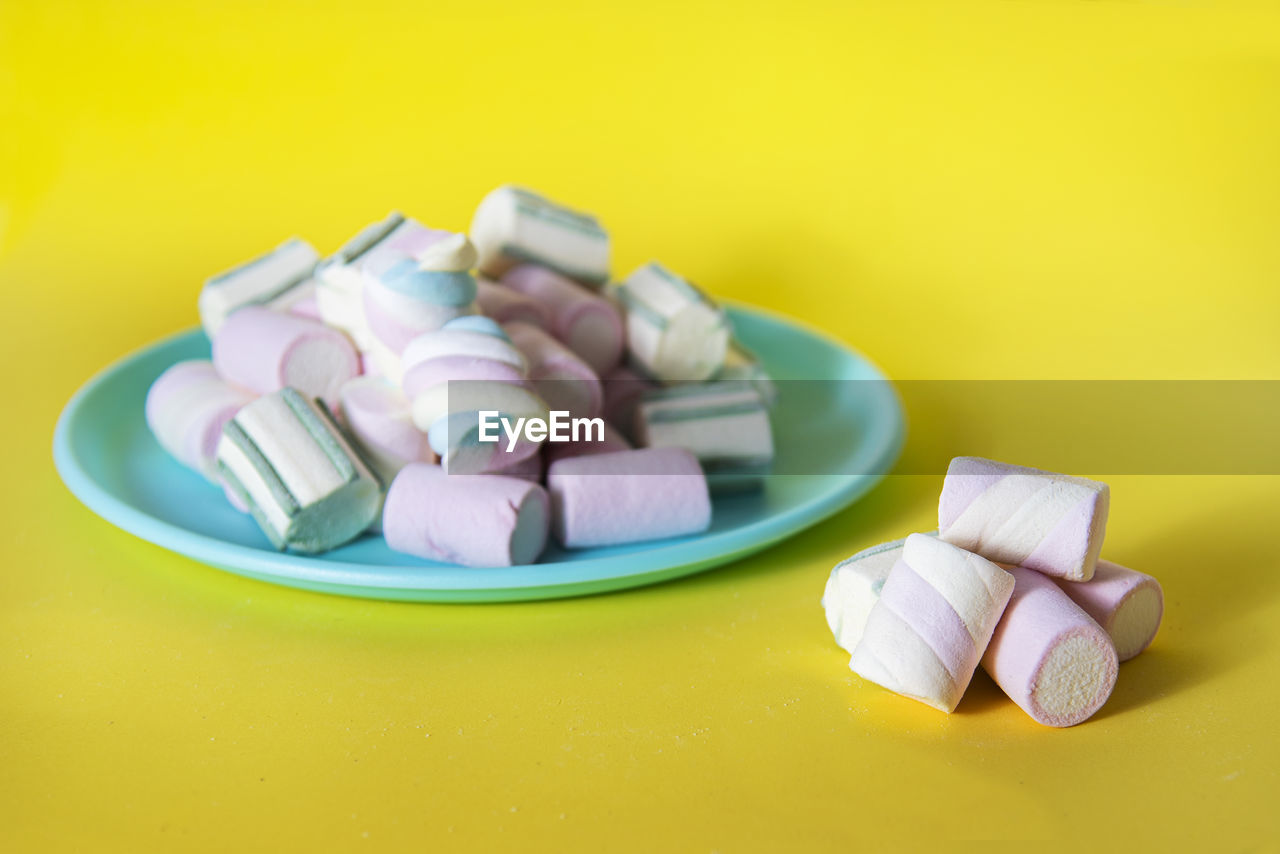 CLOSE-UP OF CANDIES IN CONTAINER