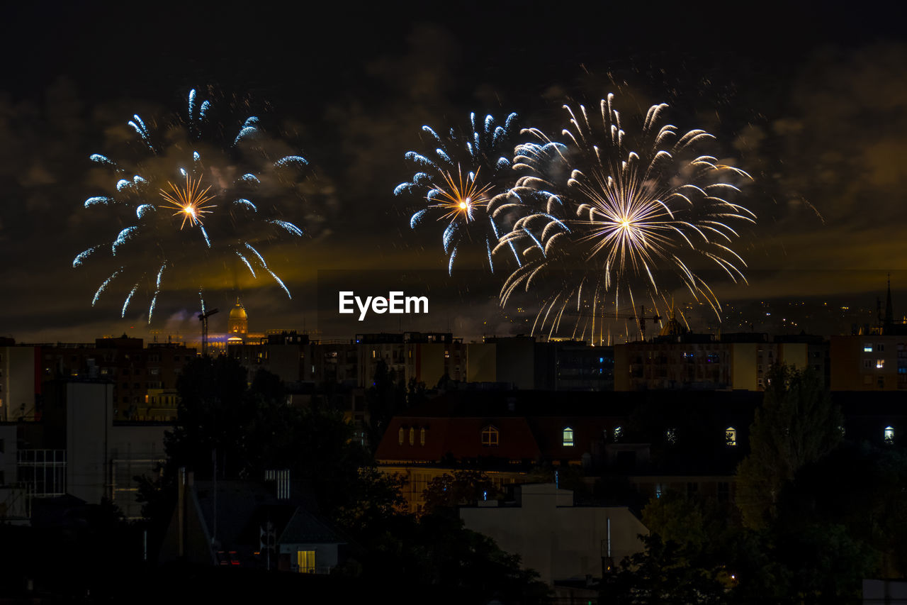 FIREWORK DISPLAY IN CITY AT NIGHT