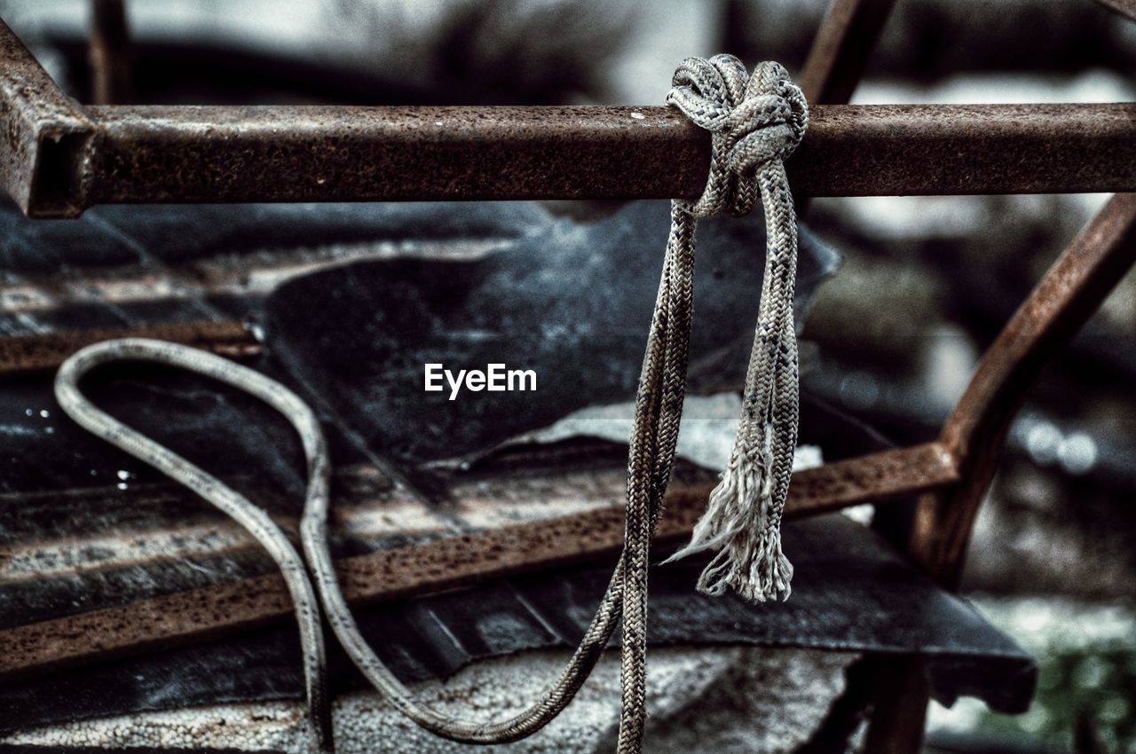 Close-up of rope tied on rusty metal
