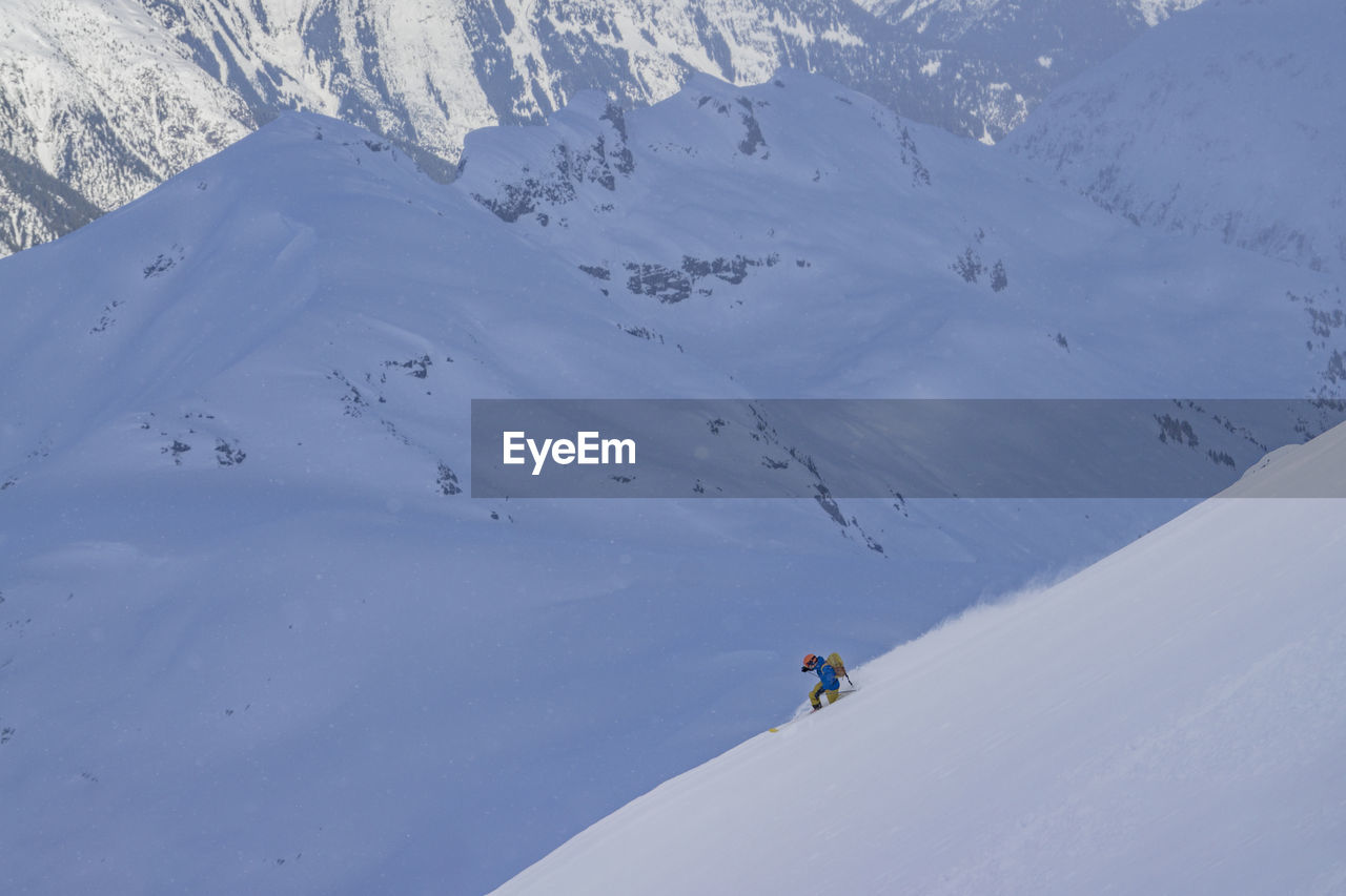 Man skiing on snowcapped mountain