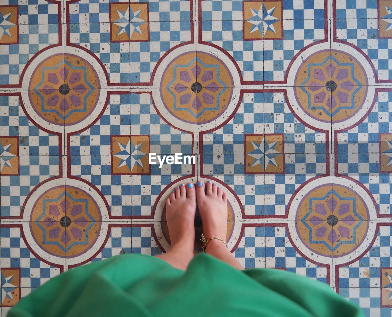 Low section of woman standing on tiled floor