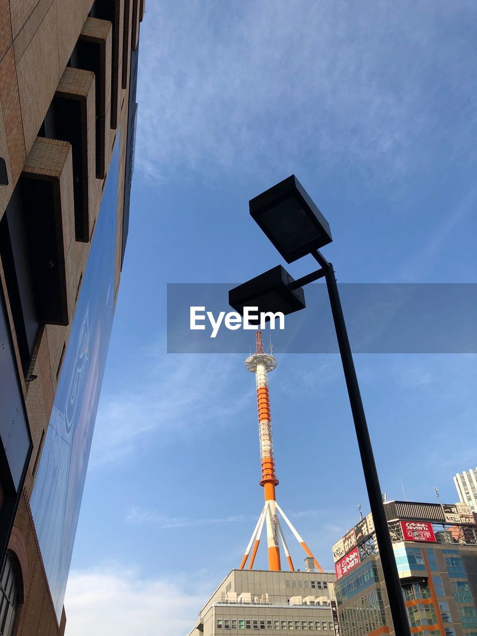 LOW ANGLE VIEW OF BUILDINGS AGAINST CLOUDY SKY