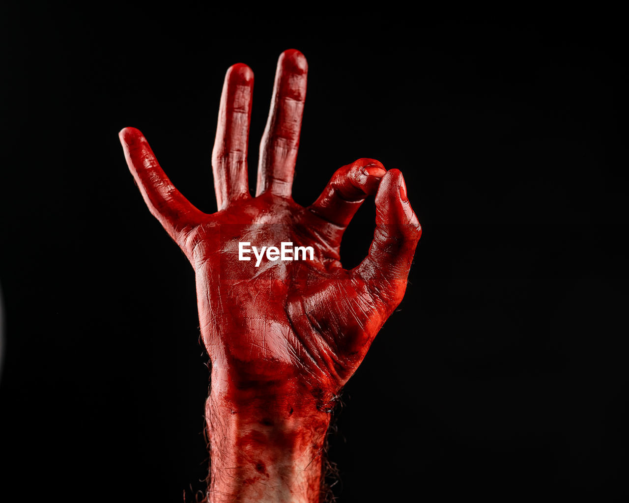 close-up of human hands against black background