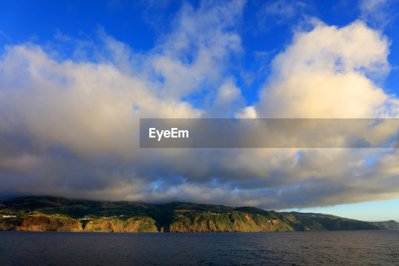 Scenic view of mountains against blue sky