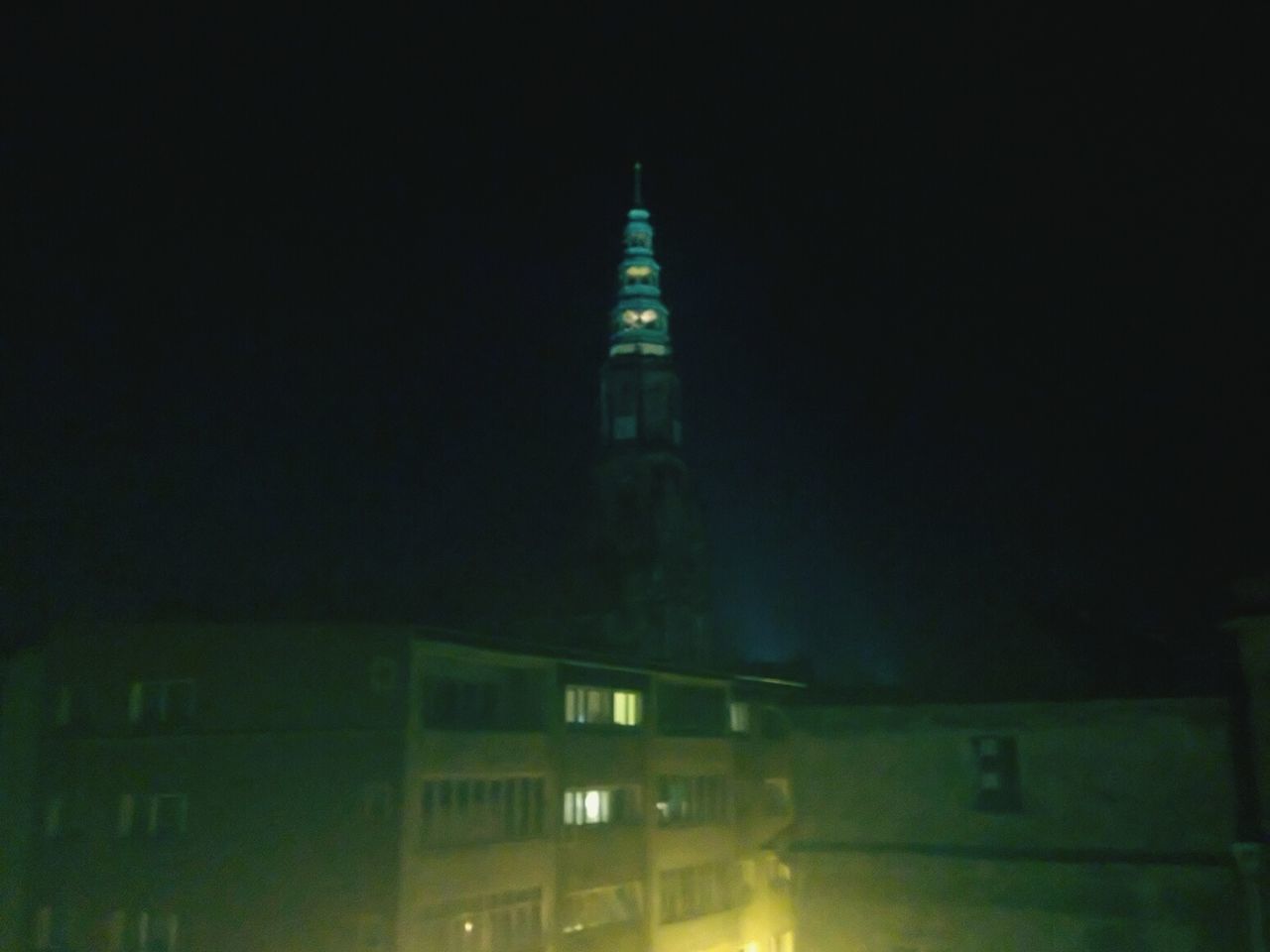 LOW ANGLE VIEW OF ILLUMINATED BUILDINGS AT NIGHT