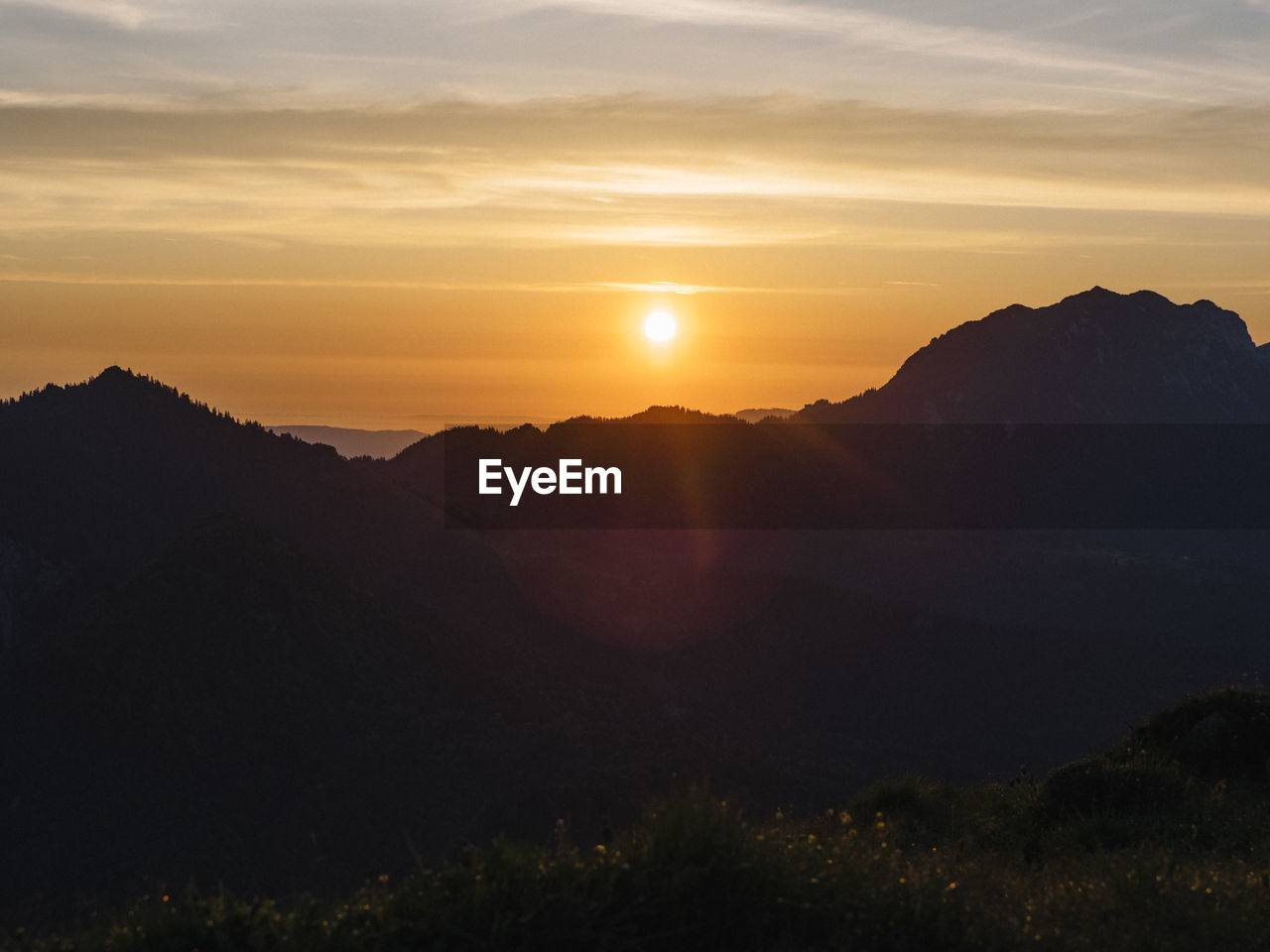 Scenic view of silhouette mountains against sky during sunset