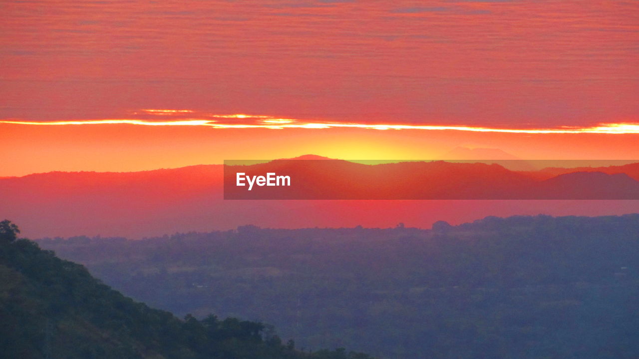 SCENIC VIEW OF MOUNTAINS DURING SUNSET