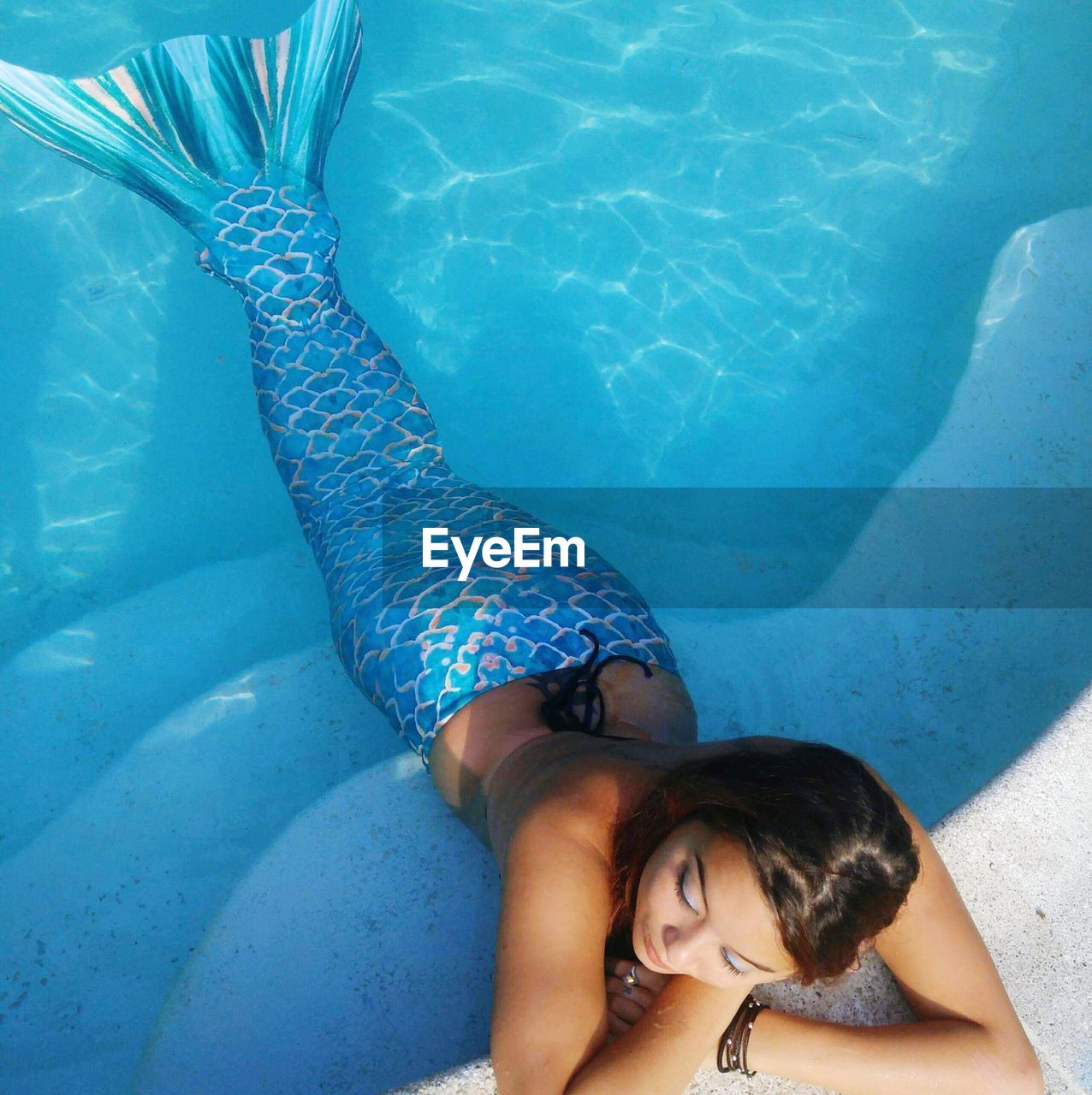 High angle view of woman wearing mermaid costume swimming in pool