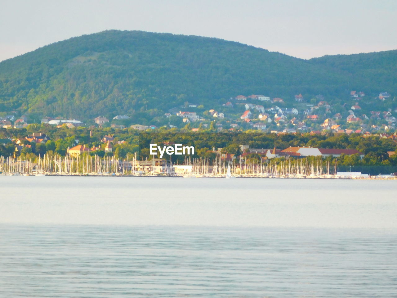 Scenic view of sea and town against sky