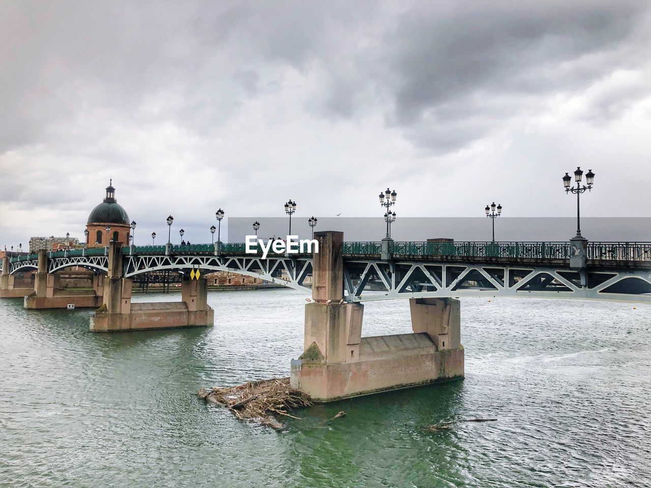 View of bridge over river against cloudy sky