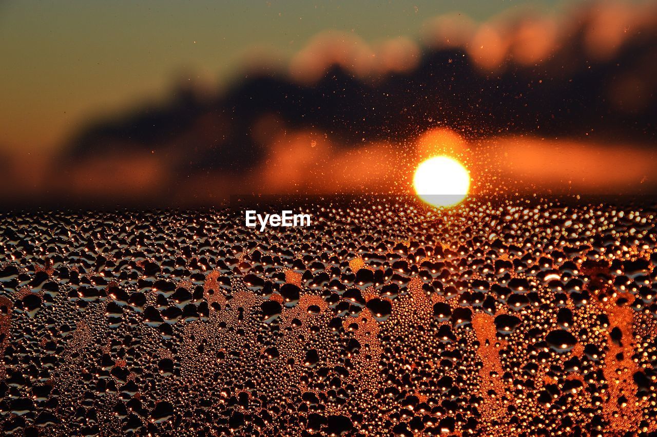 CLOSE-UP OF WET WINDOW AT NIGHT