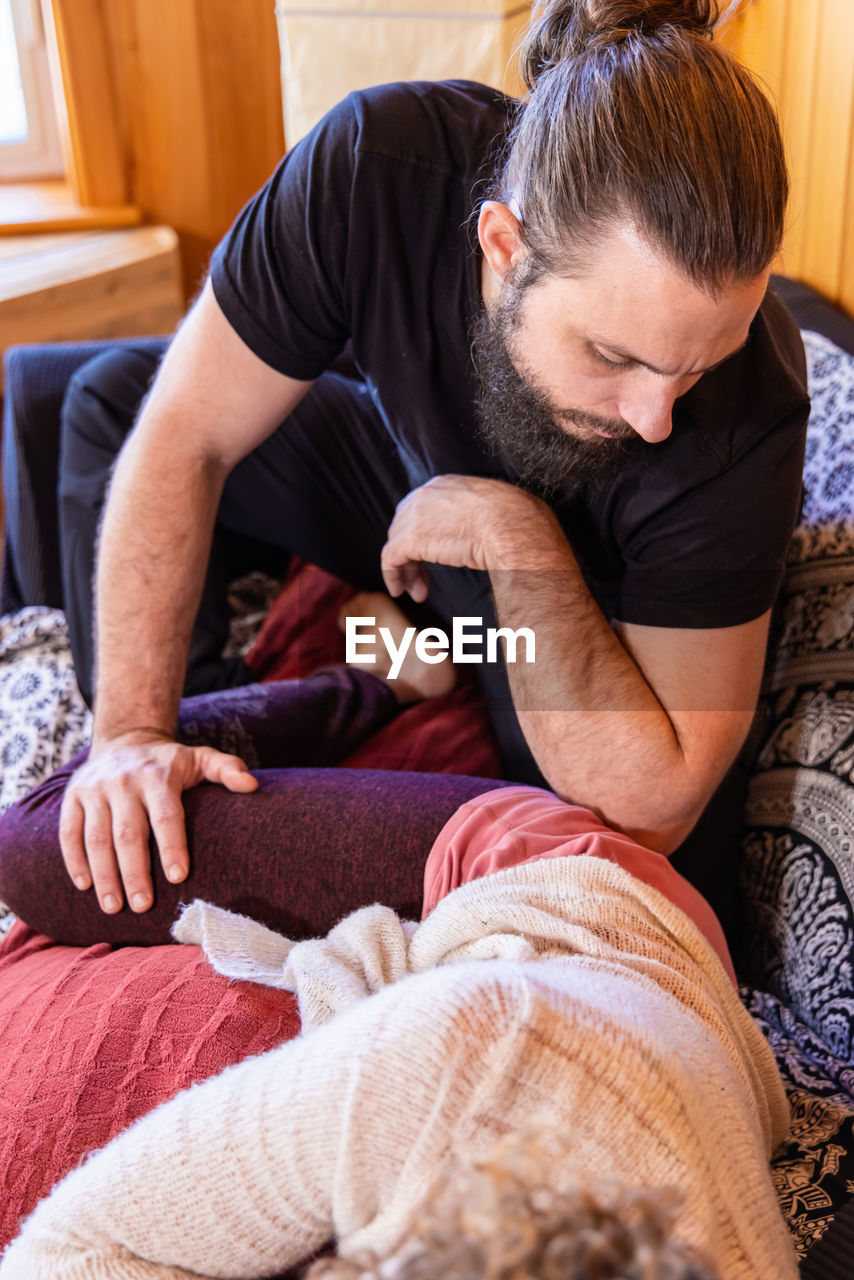 side view of boy sleeping on bed