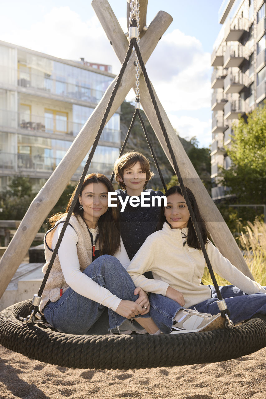 Mother with children on swing