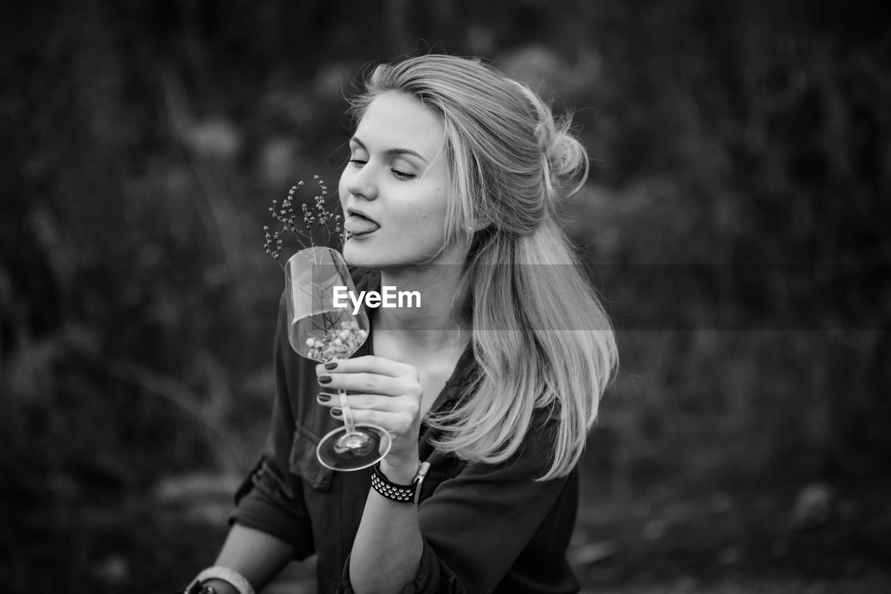 YOUNG WOMAN DRINKING GLASS