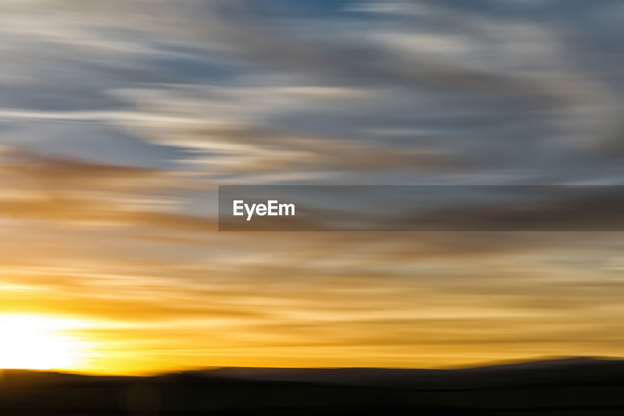 SCENIC VIEW OF DRAMATIC SKY OVER SILHOUETTE LANDSCAPE