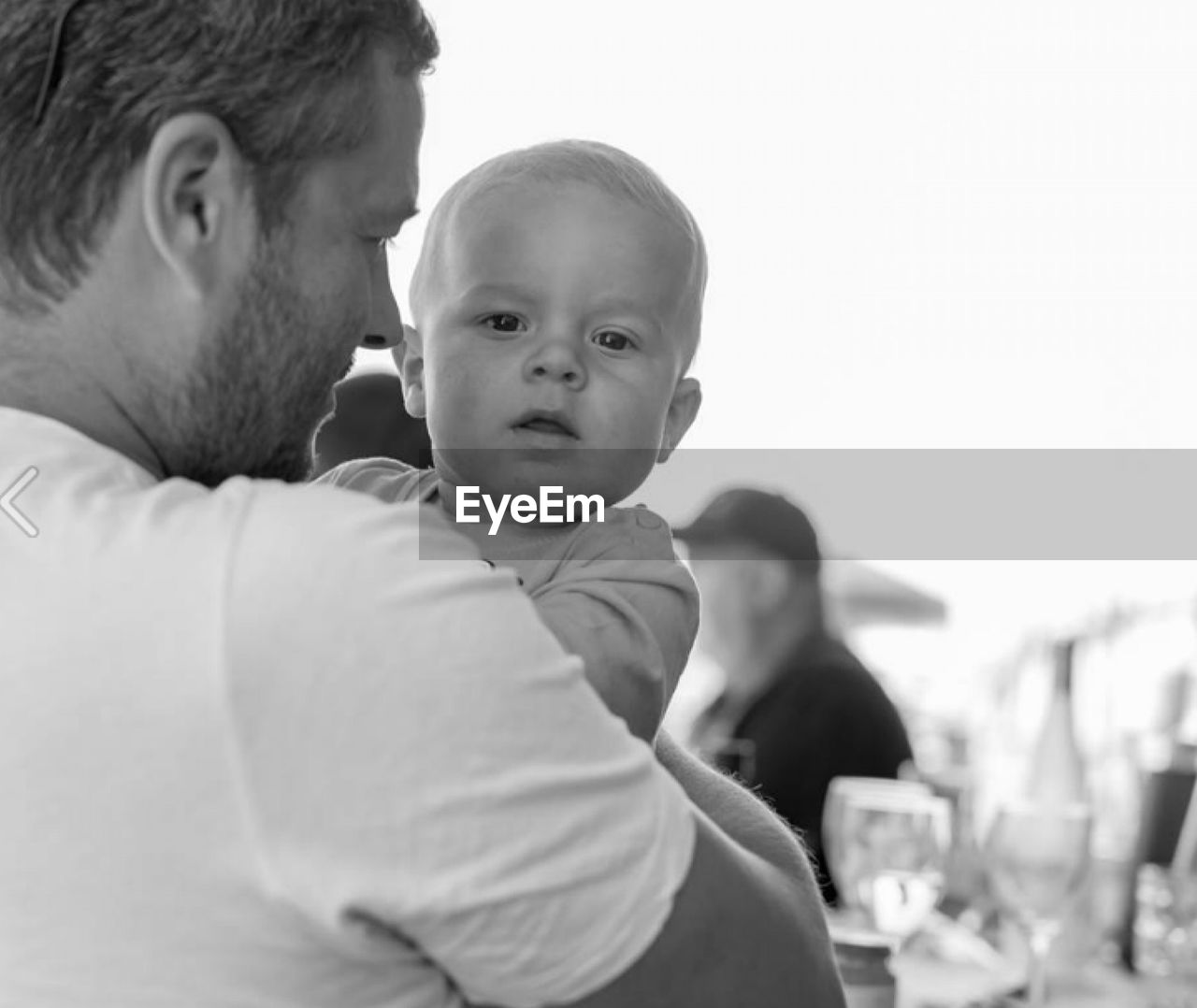 Close-up of father holding baby at restaurant