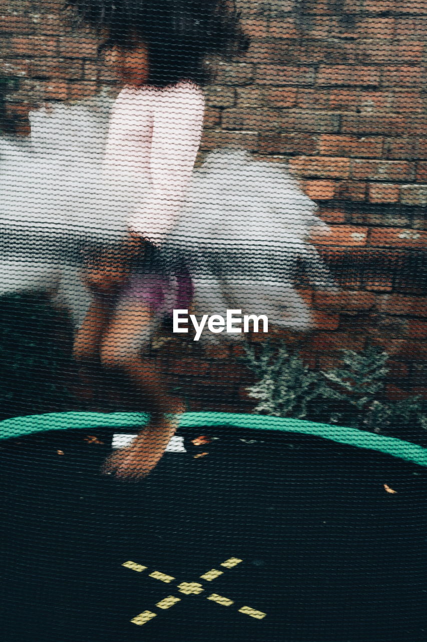 Girl jumping on trampoline