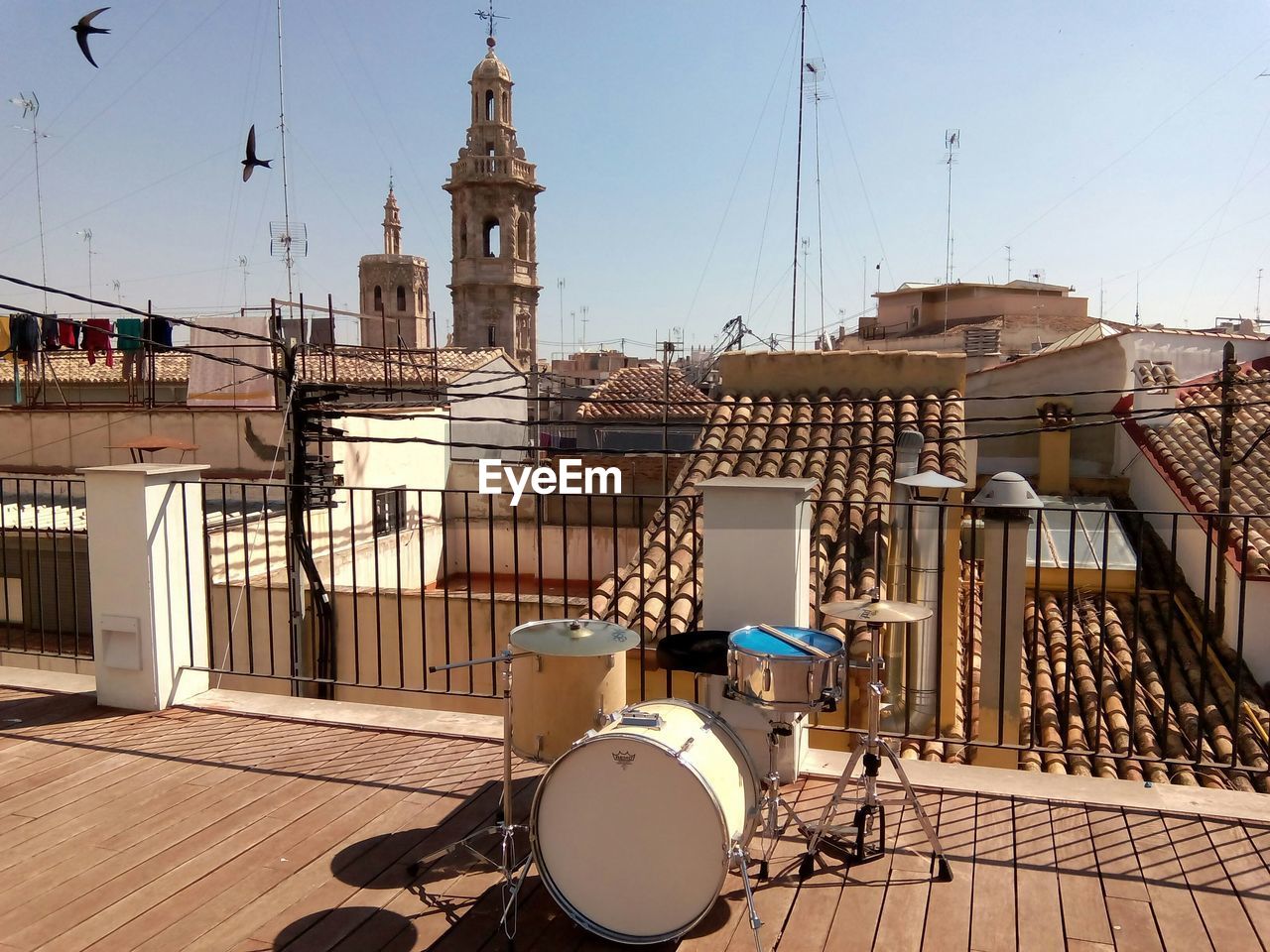 Drums on building terrace against sky