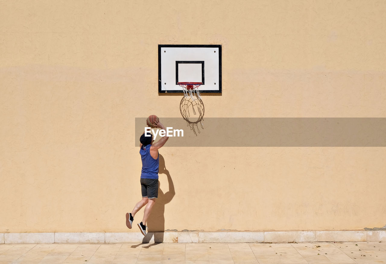 Man playing basketball outdoors