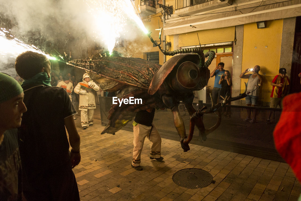 PEOPLE DANCING ON STREET AT NIGHT