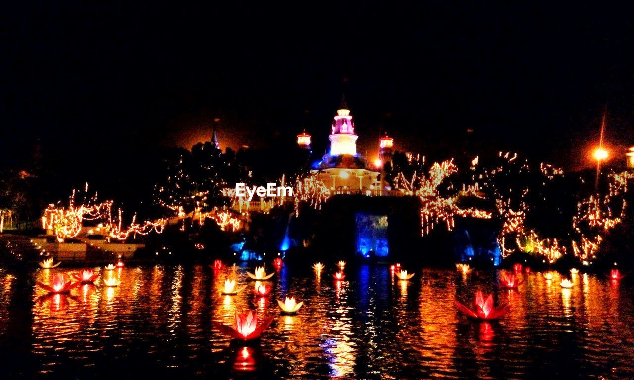 REFLECTION OF ILLUMINATED BUILDING IN WATER