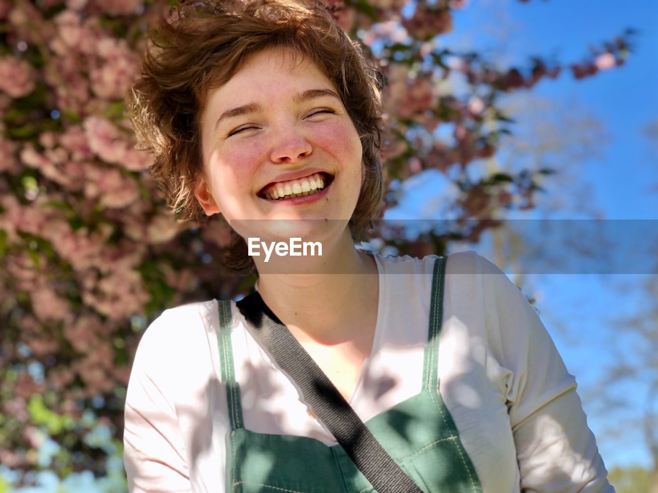 Smiling woman against trees