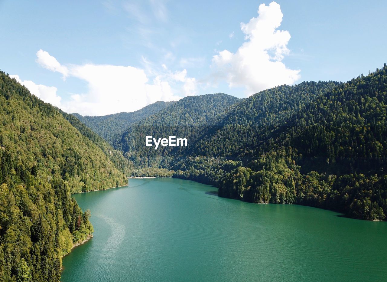 Scenic view of lake and mountains against sky