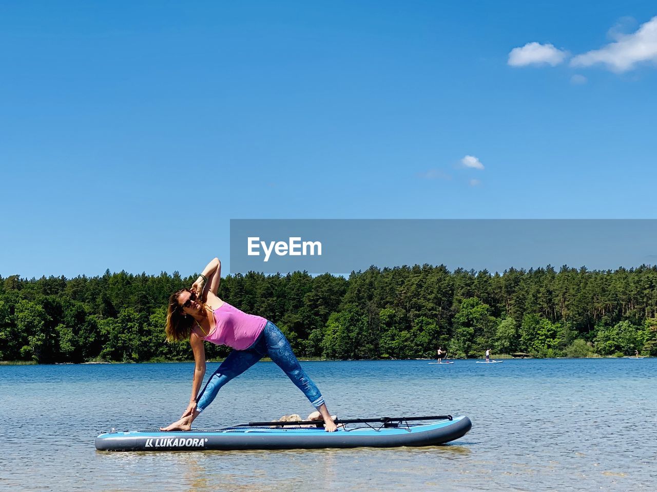 FULL LENGTH OF WOMAN IN LAKE AGAINST SKY