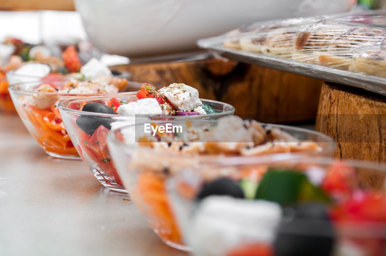 Close-up of salad in bowls on table at store for sale