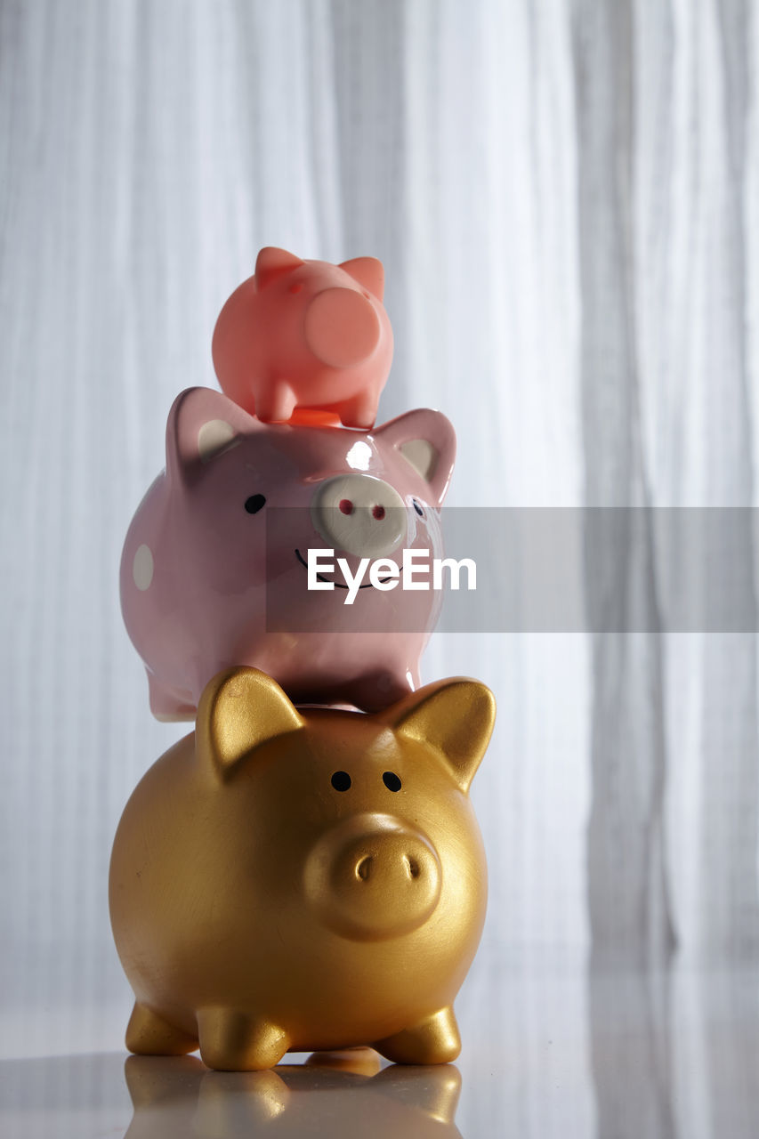 Family of piggy bank stack up in a row