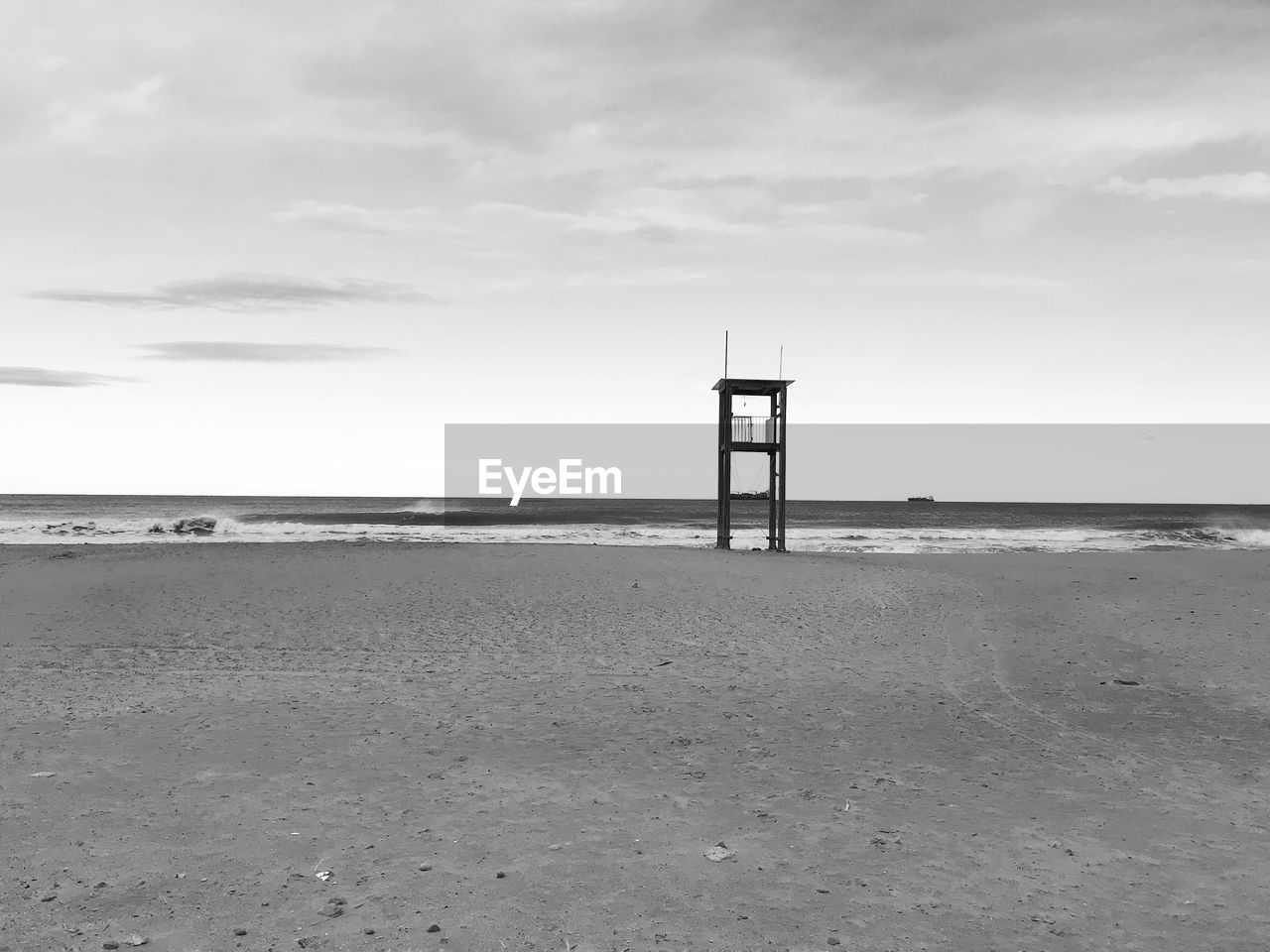 LIFEGUARD TOWER ON BEACH AGAINST SKY